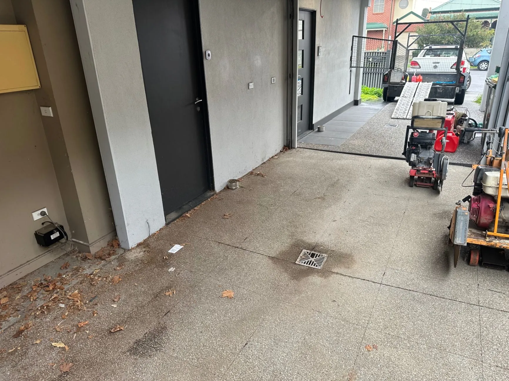 Covered access and driveway with building equipment and a trailer at an Ascot Vale site