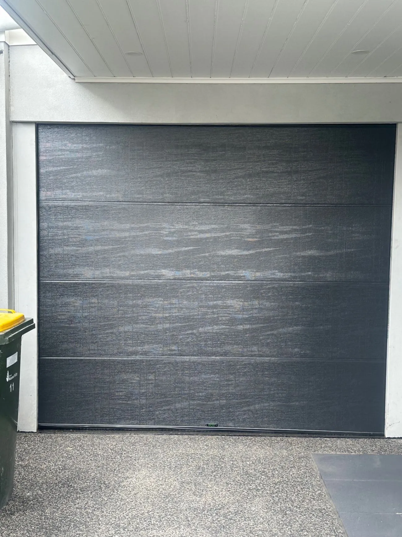 Closed dark garage door beneath a white ceiling at the completed Ascot Vale workspace