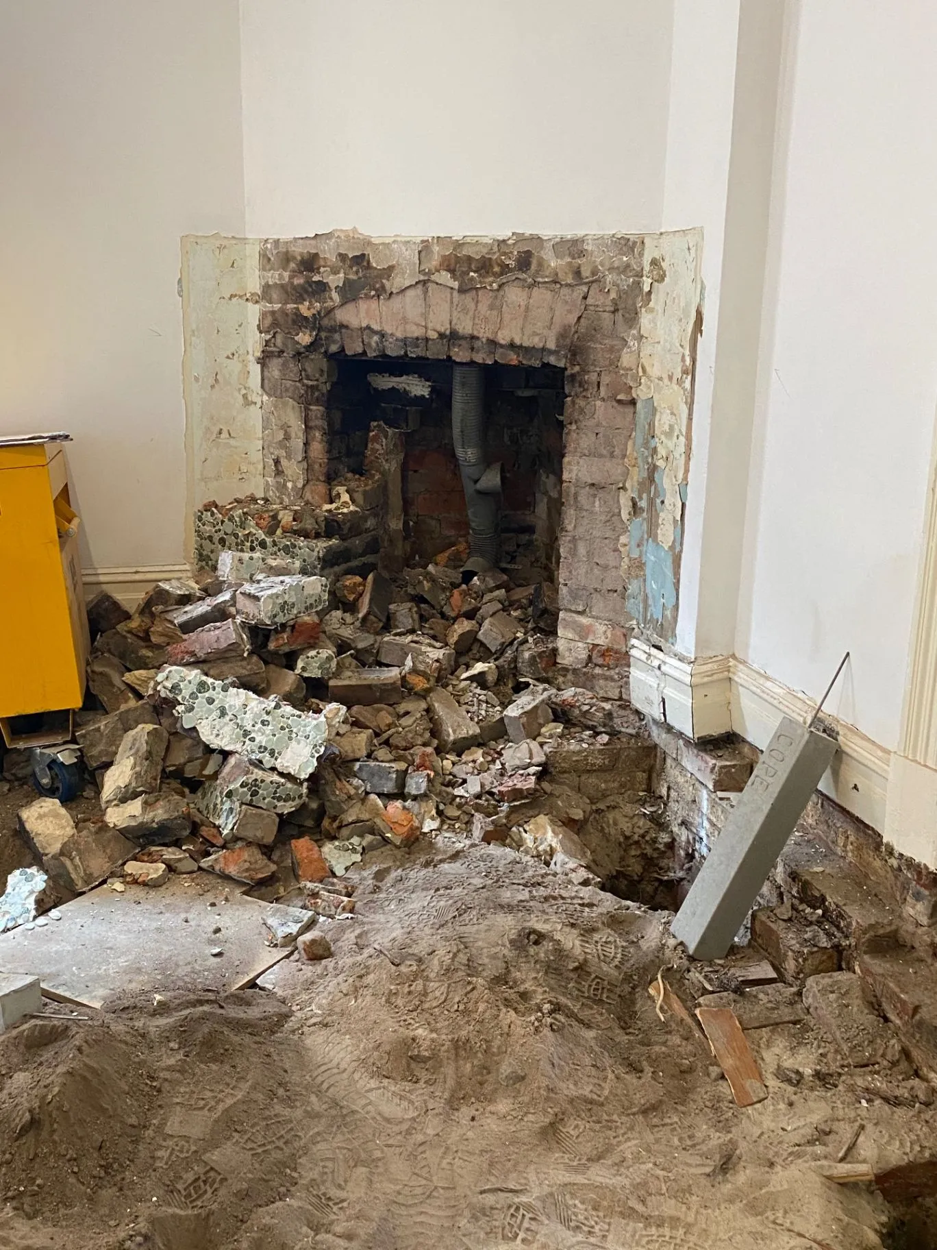 Elsternwick fireplace opened up to reveal brickwork and rubble during structural repair