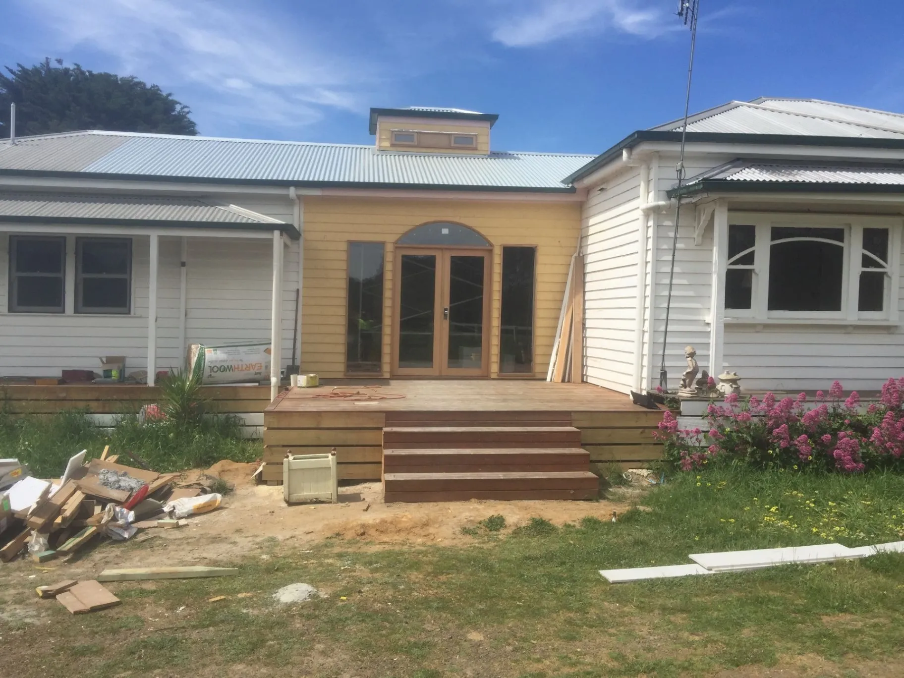 Kyneton home exterior with new timber doors and deck during construction