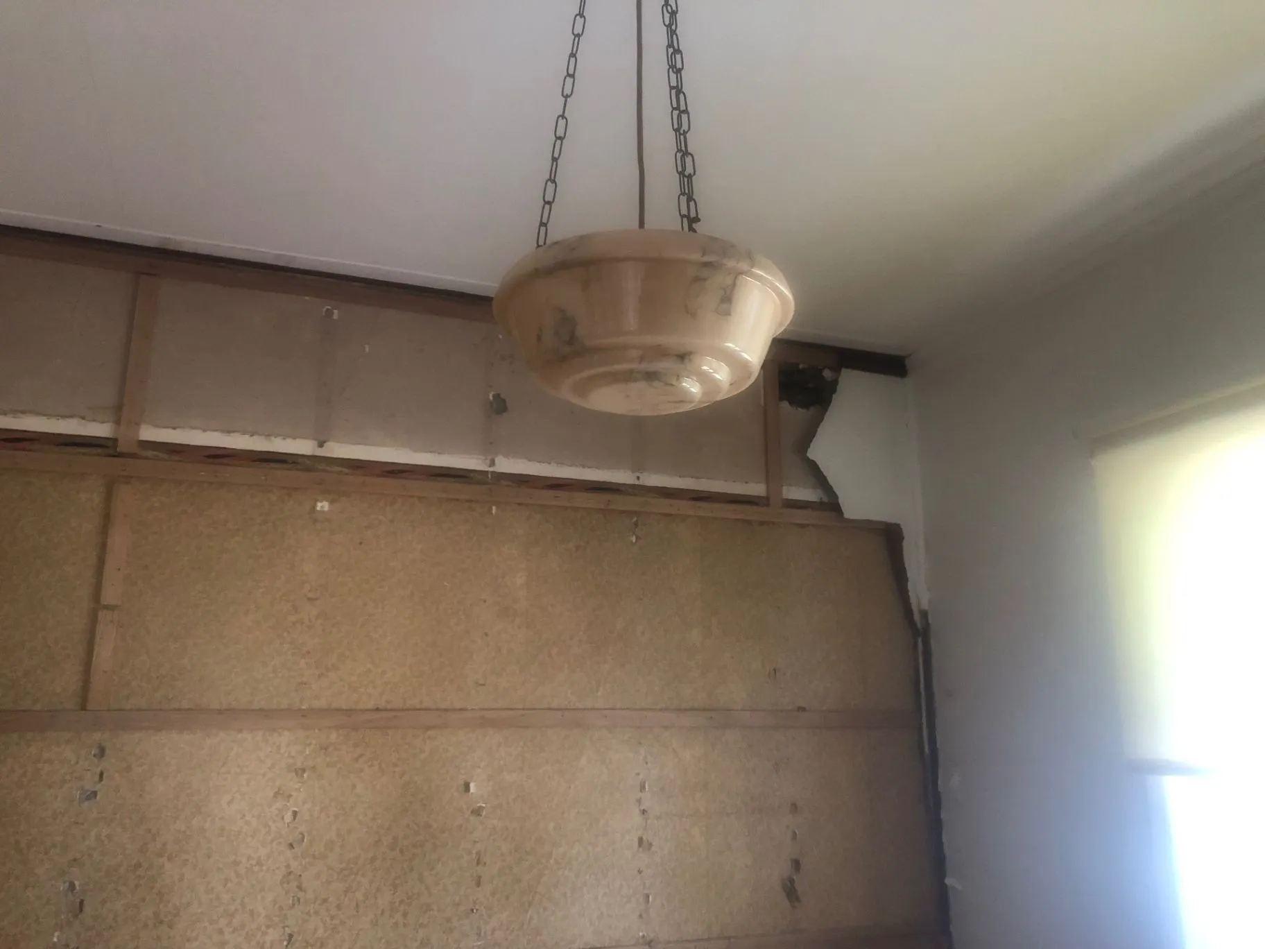 Oakleigh bedroom interior with original wall lining and pendant light