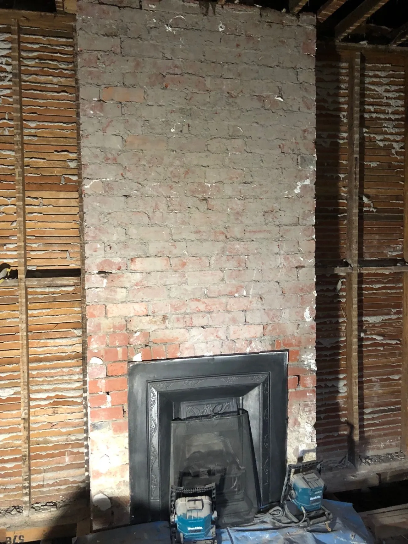 Original brick fireplace and exposed wall structure during the Oakleigh renovation