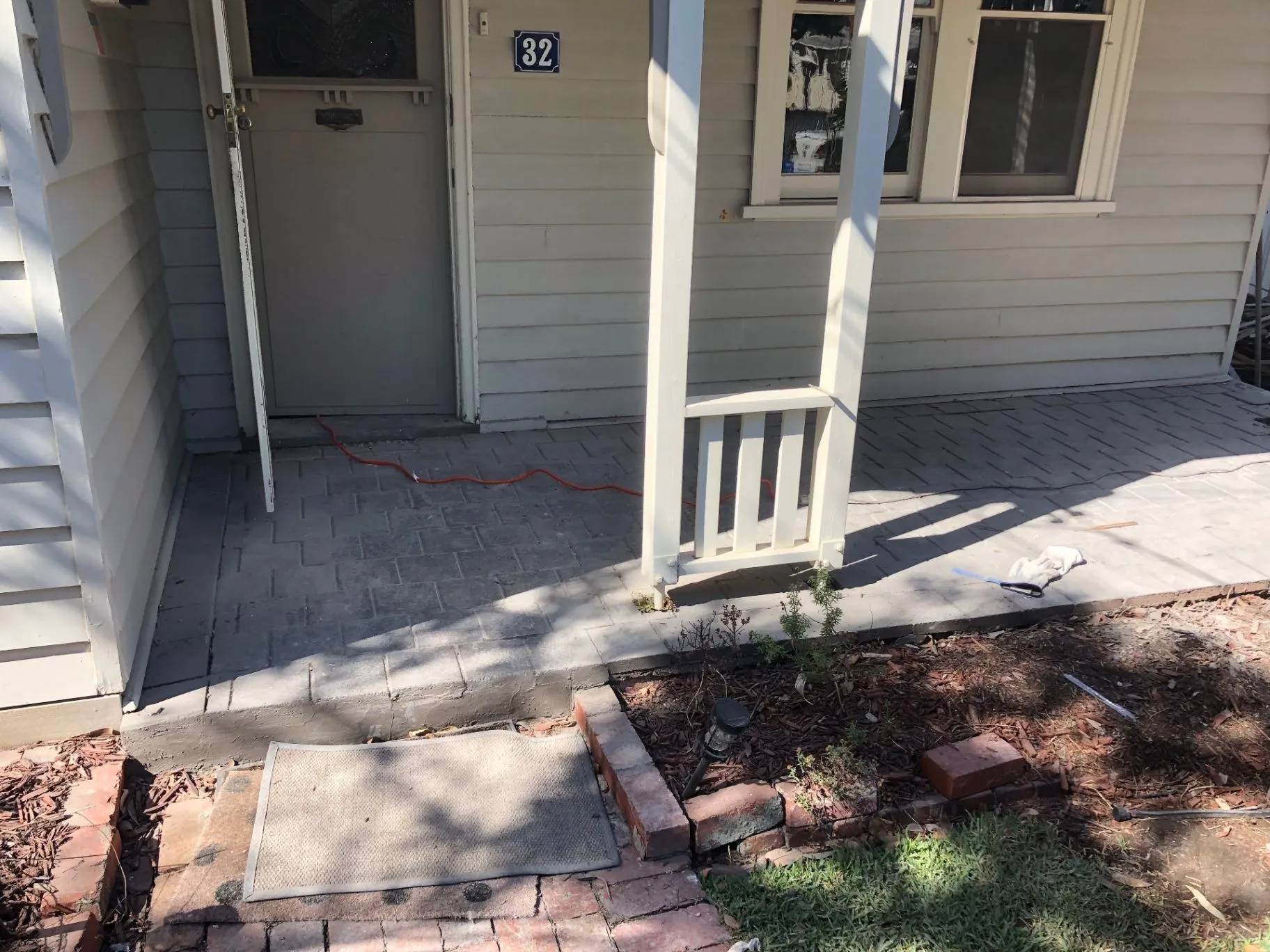 Oakleigh home entry and concrete-paved outdoor area before new decking